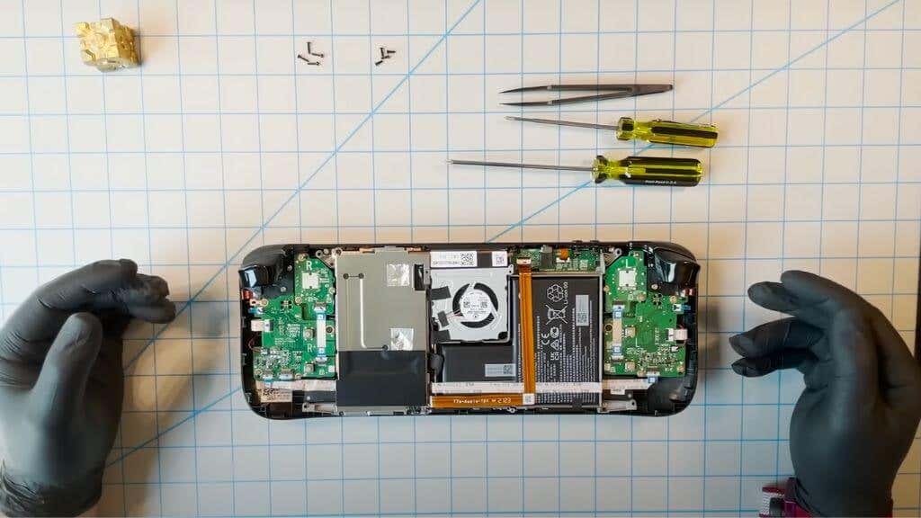 steam-deck-not-turning-on-11-fixes-to-try-6-compressed - Online Tech Tips A Steam Deck with the back removed revealing the components inside. - steam-deck-not-turning-on-11-fixes-to-try-6-compressed
